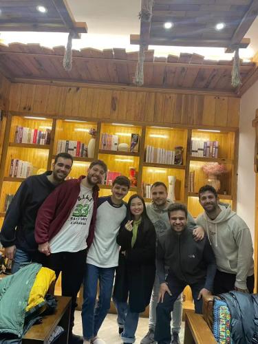 a group of people posing for a picture in a room at Chong Chong Guesthouse in Zhangjiajie