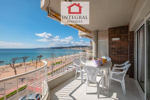 a balcony with a table and chairs and the ocean at La Mediterrània in Palamós