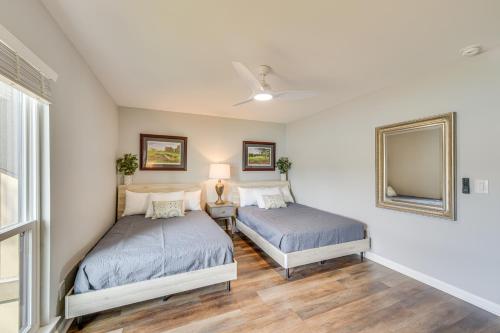 a bedroom with two beds and a mirror at Pinehurst Lake Condo Water View and Community Perks in Pinehurst