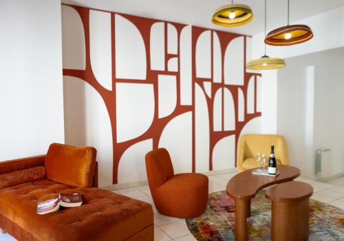 a living room with a couch and a table at Garlande Hôtel Avignon Centre in Avignon