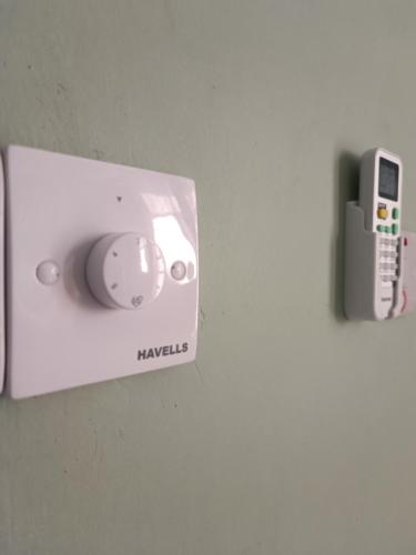 a player and a cell phone on a wall at B&B G&H house Zanzibar in Pingwe