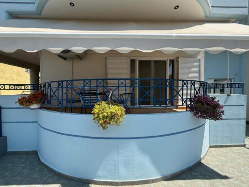 a house with a balcony with plants on it at JULIA'S APARTMENT in Igoumenitsa