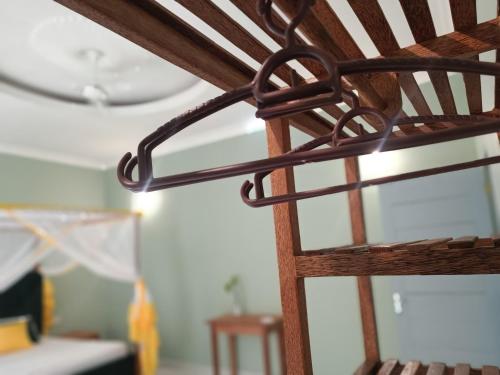 a wooden ladder in a room with a ceiling at B&B G&H house Zanzibar in Pingwe