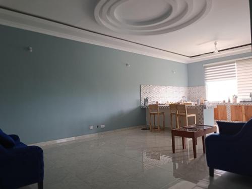 a living room with a table and chairs in it at B&B G&H house Zanzibar in Pingwe