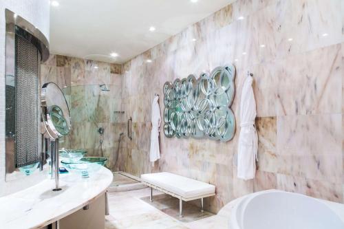 a bathroom with a sink and a toilet and a tub at Anantara New York Palace Budapest - A Leading Hotel of the World in Budapest