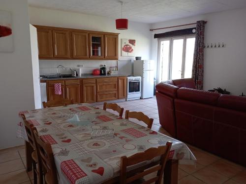 a living room with a table and a couch at Le Petit Moulin, Ste Soline in Sainte-Soline