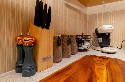 a kitchen counter with a knife block and other kitchen utensils at House Carlisle in Great Oakley