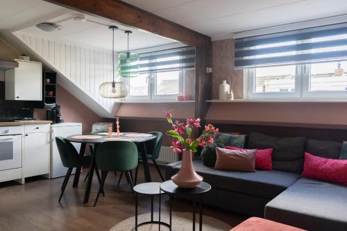 a living room with a couch and a table at Il Forno in Valkenburg