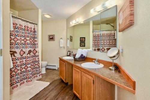 a bathroom with two sinks and a mirror at Classic AK Townhome 2BR 2BA in Kenai