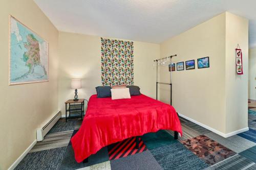 a bedroom with a red bed with a red blanket at Alaskan Bohemian in Kenai