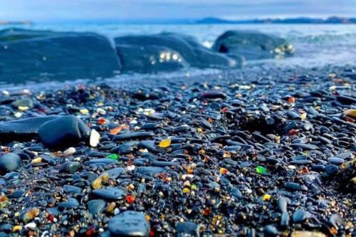 a beach covered in rocks and other items at Alaskan Bohemian in Kenai