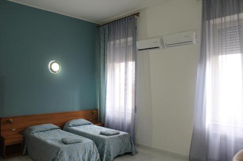 Posteľ alebo postele v izbe v ubytovaní Hotel Santa Marta
