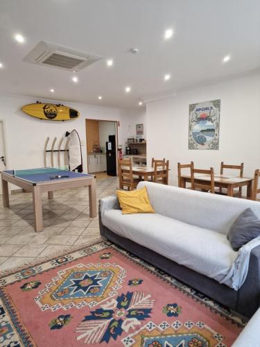 a living room with a couch and a ping pong table at Wolley - Peniche GuestHouse in Peniche