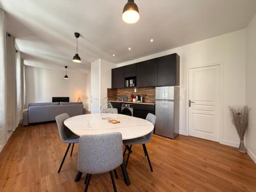 une cuisine et un salon avec une table et des chaises dans l'établissement Le Moderniste Proche des Halles et Cathédrale, à Narbonne