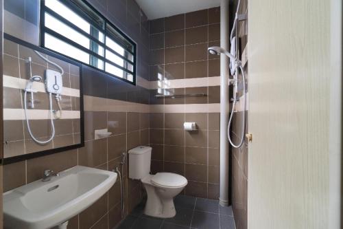 a bathroom with a toilet and a sink at Guesthouse Fasa 2B in Seri Manjung