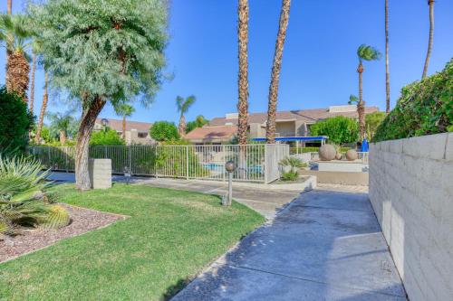 a garden with palm trees and a fence at 2BR Plaza Villas Bungalow Deluxe by Oranj Palm in Palm Springs