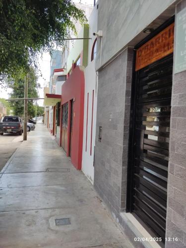 an empty street with a building with a garage at D' Barrig in Trujillo
