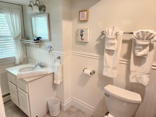 a white bathroom with a toilet and a sink at Old Orchard Beach Inn in Old Orchard Beach
