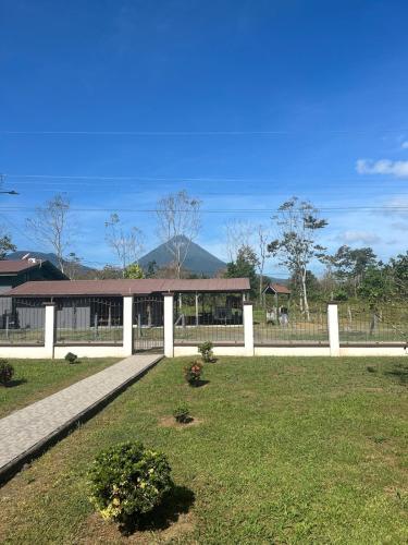 a white fence in front of a building at Volcano Refuge House in Fortuna