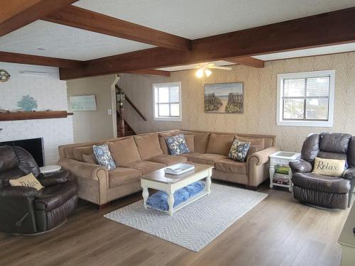 a living room with a couch and two chairs at Waterfront Salt Pond House, water view and dock in Charlestown