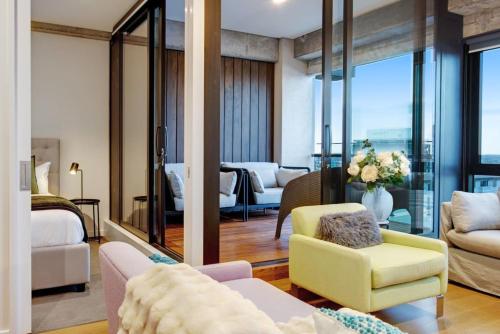 a hotel room with a view of a bedroom at Premium Cityscape Abode w Skytower view & Parking in Auckland
