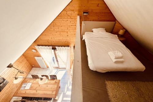 a small attic bedroom with a bed and a bathroom at Chalet T3 with garden in Xonrupt-Longemer in Xonrupt-Longemer