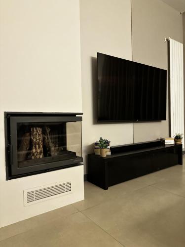 a living room with a fireplace and a flat screen tv at The Corner 1BR in Gemmayze in Beirut