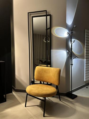 a room with a chair and a mirror at The Corner 1BR in Gemmayze in Beirut