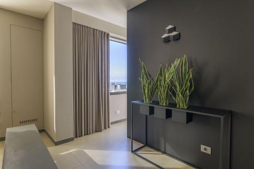 a living room with a table with plants on it at The Corner 1BR in Gemmayze in Beirut