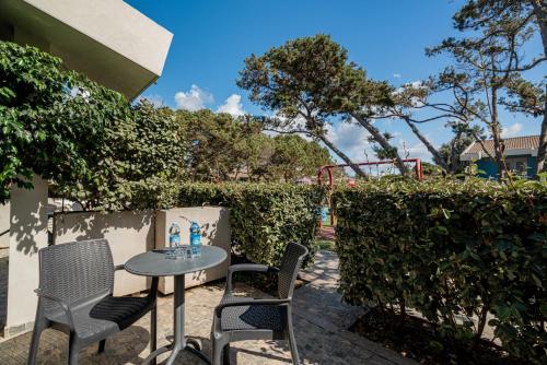 a table and chairs sitting on a patio at Club Esse Sporting in Stintino