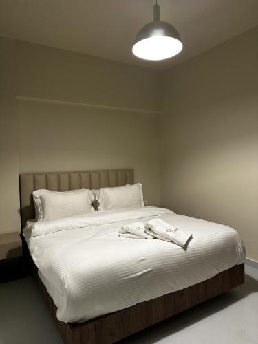 a bedroom with a bed with a shirt on it at Bond 3BR Sin El Fil in Beirut