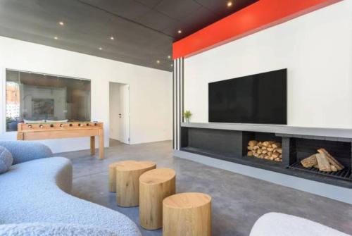 a living room with a fireplace and a television at The Club 1BR in Gemmayze in Al Mudawwar