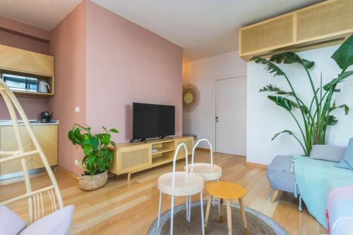 a living room with a couch and a tv at Exquisite Apartment in Bahsa, Batroun 2BR in Batroûn
