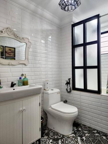 a white bathroom with a toilet and a sink at DRimba 3BR 1-7PX Pool & Near MRT Kota Damansara in Petaling Jaya