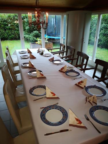 a long table with plates and napkins on it at Family chalet appartment 150 qm at Lake Zurich in Altendorf