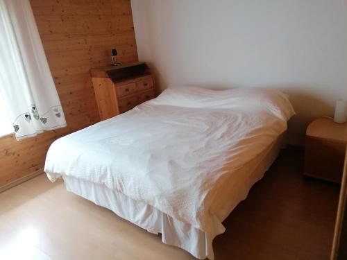 a bedroom with a white bed and a window at Family chalet appartment 150 qm at Lake Zurich in Altendorf
