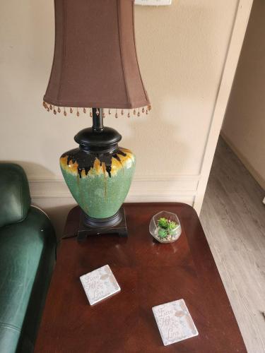 a table with a lamp on top of a table at Pop's Place -Lakeview 3bd 2 ba on 6 acres in Fort Gibson