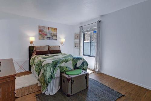 a bedroom with a bed and a suitcase at Palm Canyon Villas Escape in Palm Springs