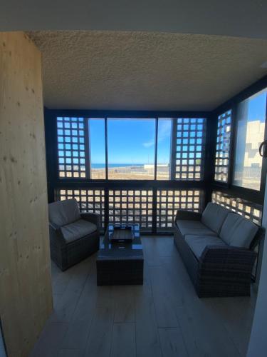 un salon avec un canapé et une table dans l'établissement Appartement Horizon Marin vue Océan, à Lacanau-Océan