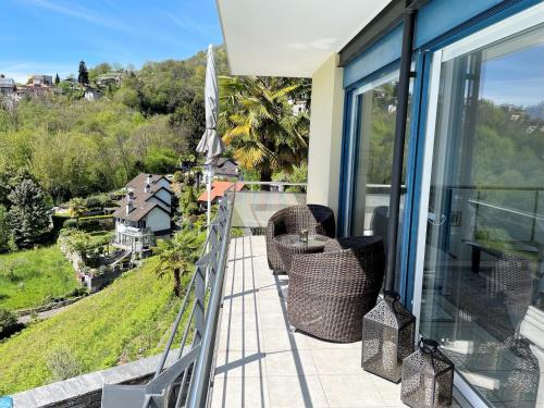 a balcony with chairs and a view of a city at Casa Lucciola by Fewotessin in Contra