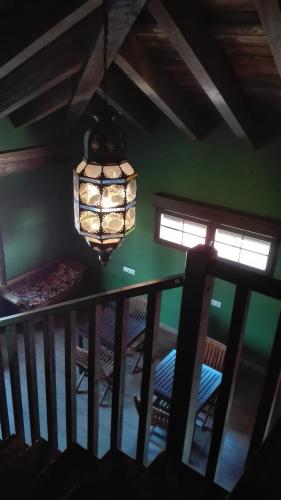 a chandelier in a room with a table and chairs at Albergue la Medina de Camponaraya in Camponaraya