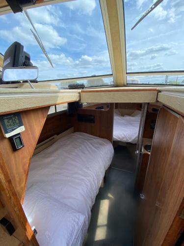 a room with two bunk beds in a boat at The River Thames - Surrey Boat in Thorpe