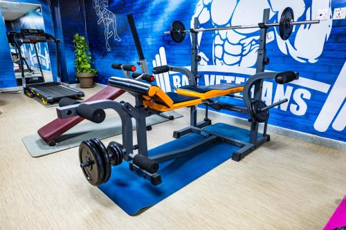 a gym with a squat rack and weights at Al Ritz Al Madinah in Al Madinah