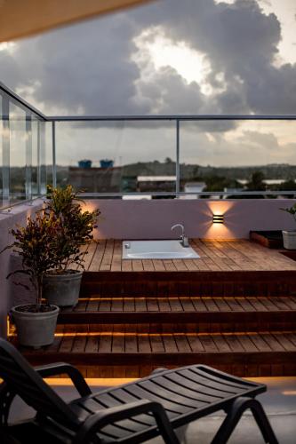 a balcony with a table and chairs on a ship at Atlântico Sul Hotel in Porto De Galinhas