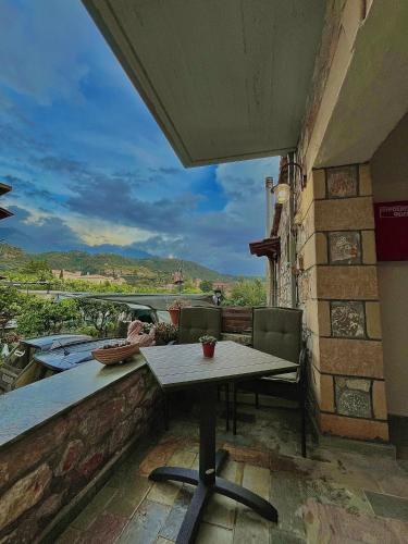 a table on a balcony with a view at Voula Pansion in Kardamili
