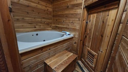 a bathroom with a tub in a wooden cabin at Snowriver Mountain Resort in Wakefield