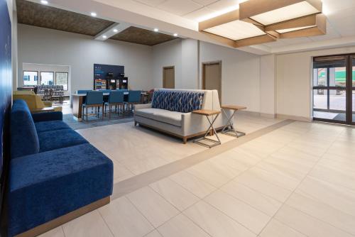 a lobby with a couch and chairs and a table at Holiday Inn Express & Suites Leesburg - Historic District by IHG in Leesburg