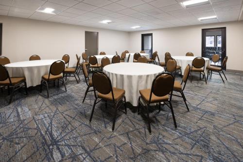 a conference room with tables and chairs in it at Holiday Inn Express & Suites Leesburg - Historic District by IHG in Leesburg