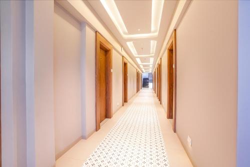 an empty corridor in a building with a ceiling at Hotel Regency in Vasai
