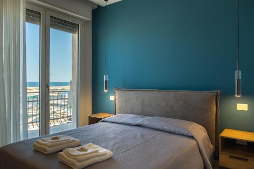 a bedroom with a bed with two towels on it at Pier Boutique Apartment in Mola di Bari